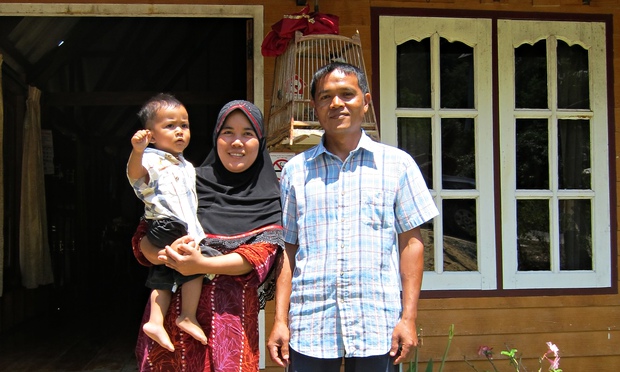 Bang Hem and Dae, holding Farit, in Ban Talae Nok village on Thailand's Andaman coast